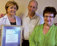 Charlene Van Niekerk (l), internal sales, Gary Czapski and Eugenia Waliszewiski, automotive office manager, with the award certificate.